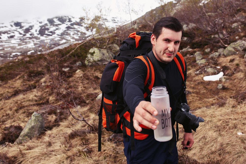 touriste atteint la bouteille avec le lettrage «ma bouteille»