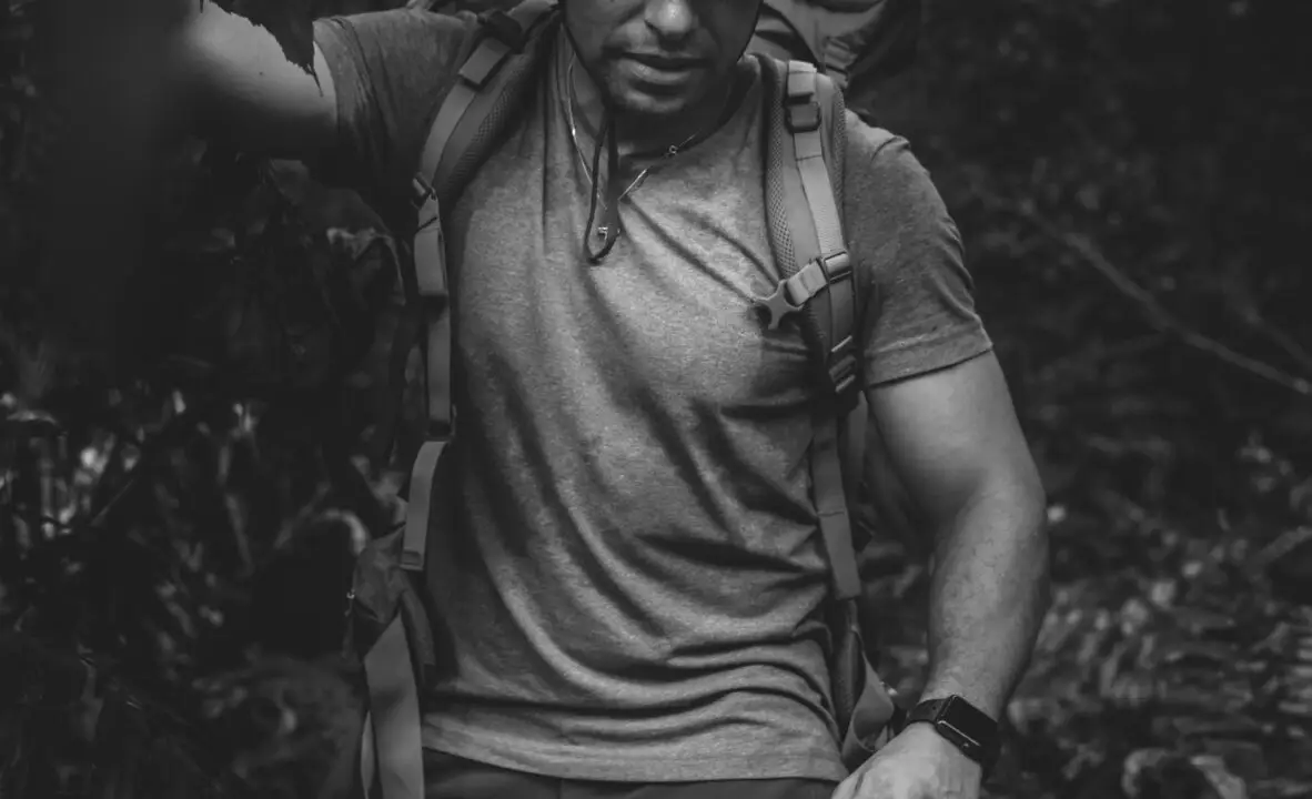 male backpacker trekking in the forest