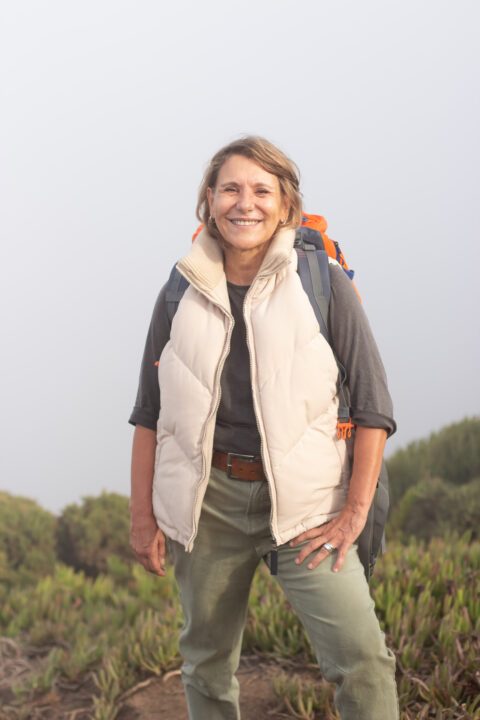 Femme senior souriante avec un sac à dos, prête pour une activité physique douce comme le rucking